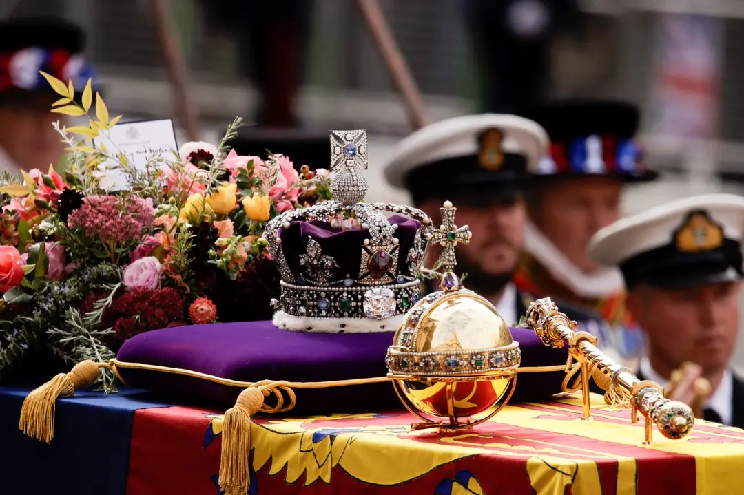 Caixão da rainha Elizabeth acompanhado de um globo religioso, seu cetro, sua coroa sobre uma almofada e um buquê (Foto: Alkis Konstantinidis/Pool/REUTERS)